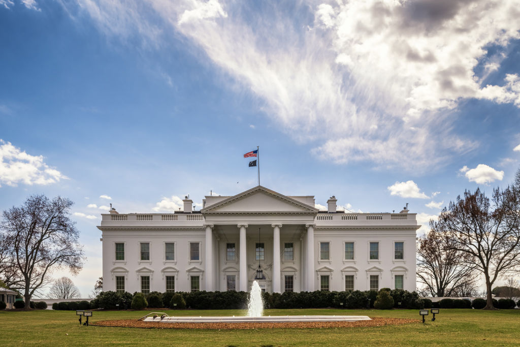 Museum-and-Library-Union-Launches-Legal-Battle-Against-White-House.jpg A white columned building with a fountain in front of it.