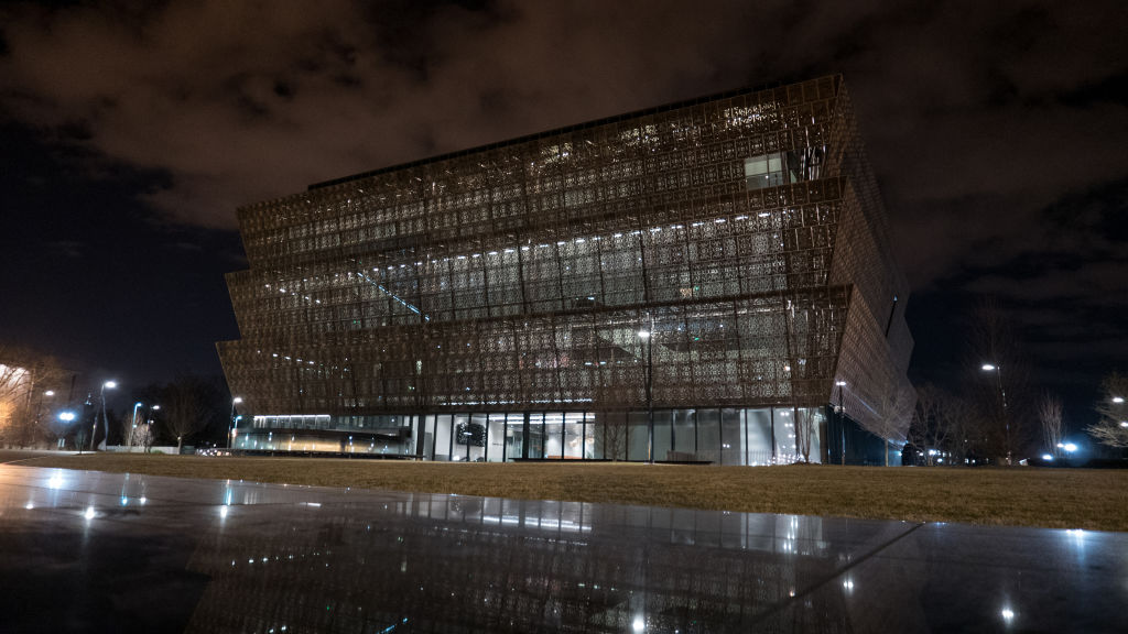 Smithsonian-Director-Says-Museum-Will-Be-Non-Partisan-in-Staff-Memo.jpg A night time view of a museum exterior.