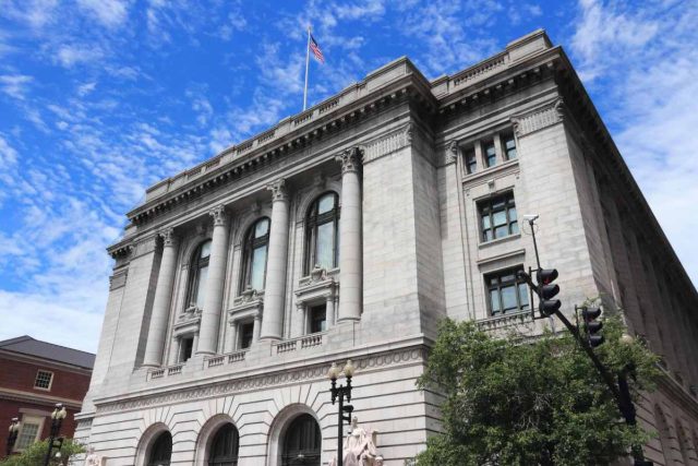 Trump-appointed-judge-orders-Trump-admin-to-turn-the-funding-spigots.jpeg A flag flies over the U.S. District Court for the District of Rhode Island.