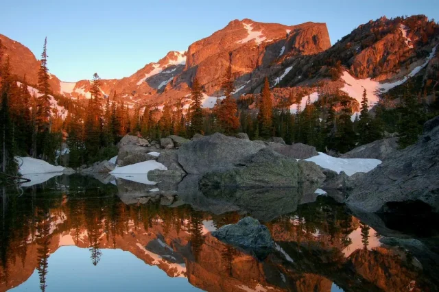 US-National-Parks-Can-Bring-Back-1000-Fired-Employees.jpg View of mountains and lake at Rocky Mountain National Park Colorado