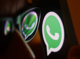 WhatsApp logo reflected on sunglasses and displayed on a phone screen.