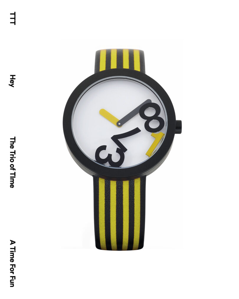 Stylish watch with large black numerals at odd angles on a white face. Black and yellow striped band. Text: 