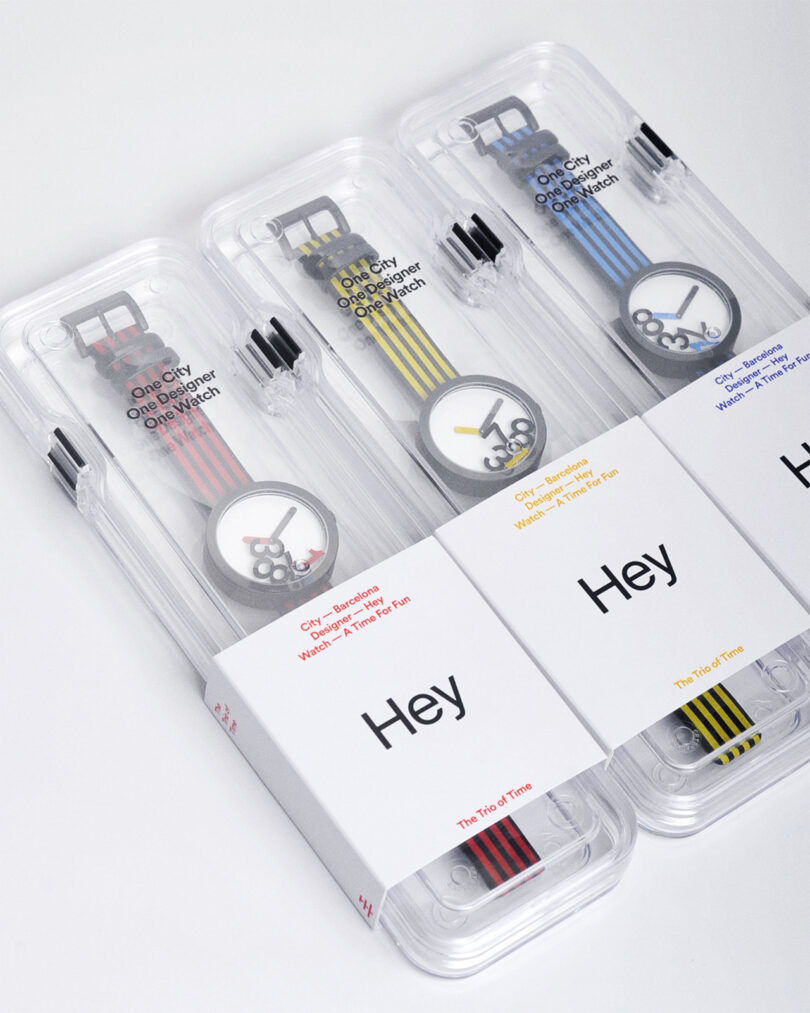 Three colorful wristwatches in transparent packaging, each with striped bands and circular dials, branded as 