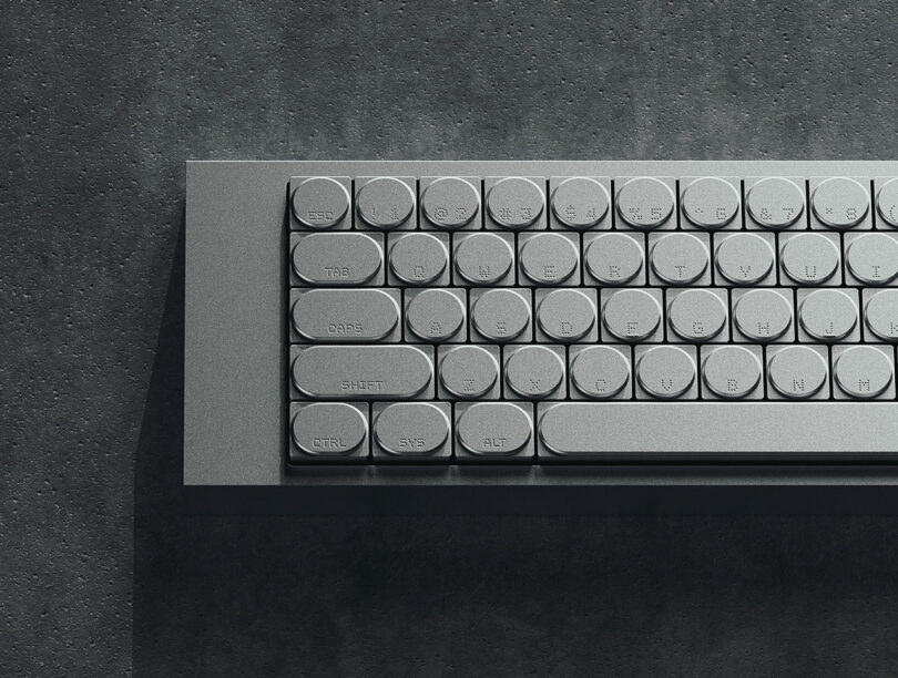 A metallic keyboard with round keys, including labeled buttons such as 
