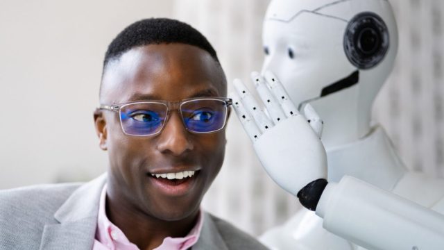 1748455682_Hidden-AI-instructions-reveal-how-Anthropic-controls-Claude-4.jpg Stock Photo: AI Cyborg Robot Whispering Secret Or Interesting Gossip