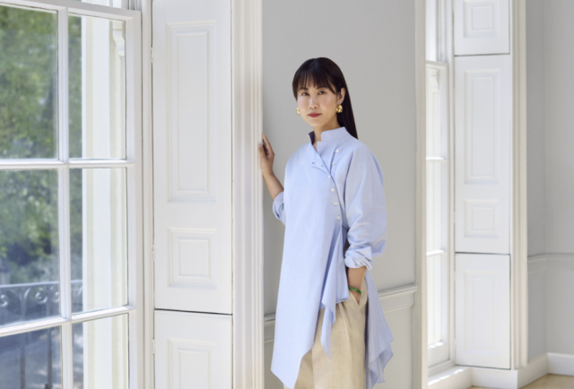 Chinese-Collector-to-Open-Non-Profit-Art-Space-in-London.png A Chinese woman stands next to a window.
