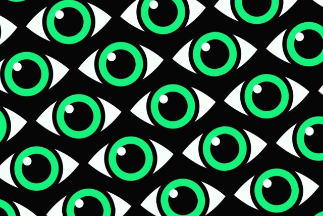 Cocospy-stalkerware-apps-go-offline-after-data-breach.jpeg Green eyes with a white glint on a patterned black background.