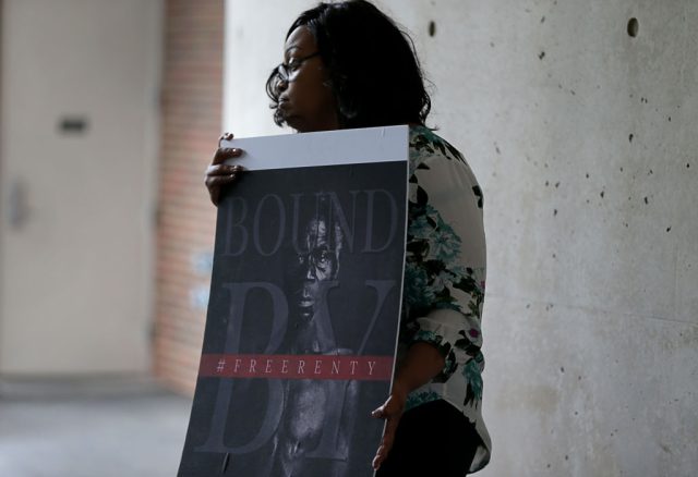Harvard-Returns-Early-Images-of-Enslaved-Americans-to-Descendant-after.jpg CAMBRIDGE, MA - JUNE 20: Shonrael Lanier, a descendant of former slave Renty Taylor, holds a sign at a press conference held at Harvard University to talk about the lawsuit that the family has filed against the university in Cambridge, MA on June 20, 2019. Under cover from a torrential downpour, two families came together on Harvard Universitys campus Thursday to demand that the institution turn over historical photographs of two slaves and reckon with its history of white supremacy. Tamara Lanier, a Connecticut woman who sued Harvard in March, has said shes a descendant of Renty and his daughter Delia, two slaves who were forced in 1850 to pose naked for daguerreotypes, or early photographs. She said the images, discovered in 1976 and stored in Harvards Peabody Museum, rightfully belong to her, and her lawsuit alleges that Harvard is shamelessly capitalizing on them. She was joined at a press conference Thursday by descendants of controversial Harvard scientist Louis Agassiz, who commissioned the daguerreotypes in an attempt to support his theory of white biological superiority. (Photo by Jonathan Wiggs/The Boston Globe via Getty Images)