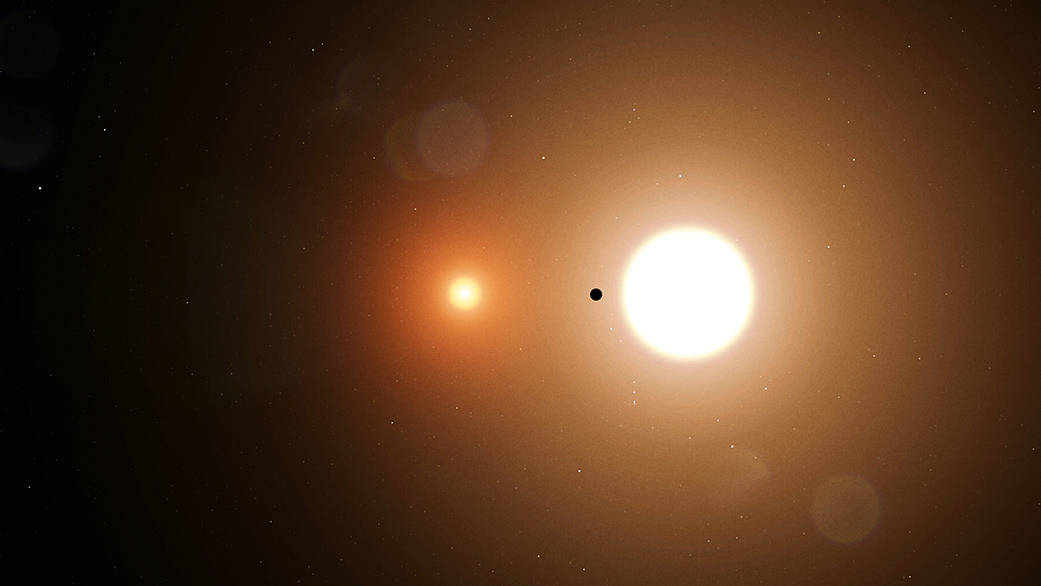 Image of two stars, one small and a dull orange, one larger and a bright yellow. In between is a small dark object.