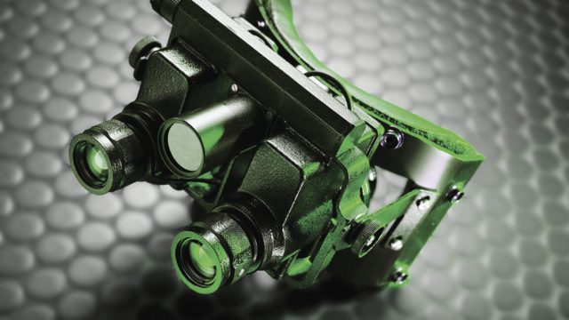 New-material-may-help-us-build-Predator-style-thermal-vision-specs.jpg Image of bulky night vision goggles made of black material, but lit with a green light.