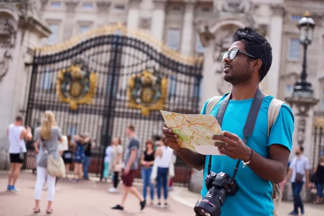 Whats-Driving-Travel-Plans-of-Indians-This-Summer.jpeg A tourist a map and his camera.