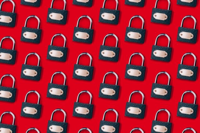 X-hits-pause-on-its-encrypted-DMs-feature.jpg a pattern of locks on a red background