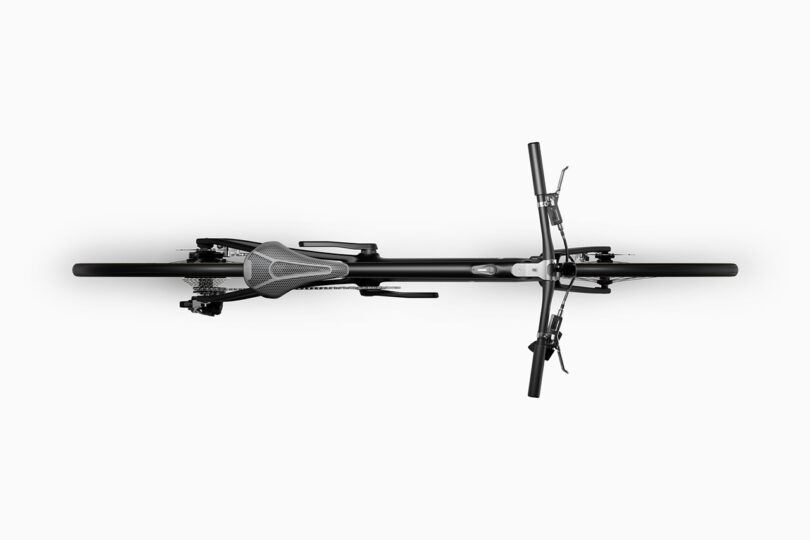 Top view of a bicycle showing handlebars, seat, and two wheels with a sleek black and gray design on a white background.