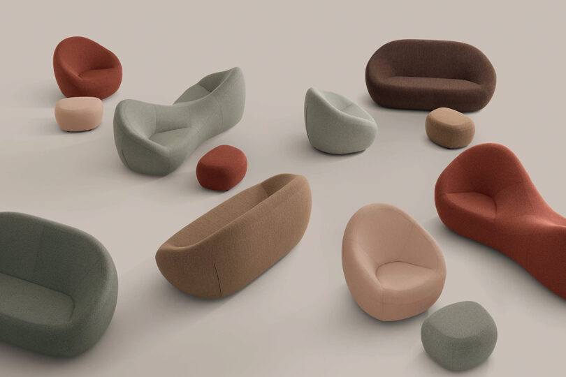 A variety of modern, curved sofas, armchairs, and ottomans in muted earth tones arranged on a plain, light background.
