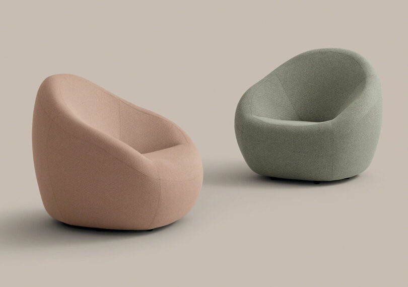 Two modern, rounded armchairs—one pink and one gray, inspired by Jean Nouvel Coalesse design—are placed on a plain beige background.