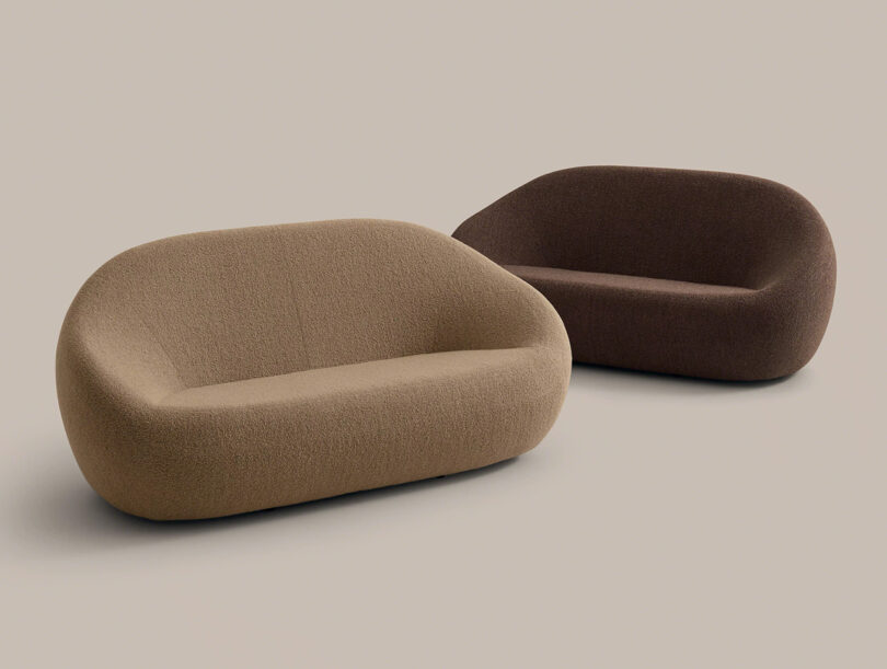 Two modern, rounded sofas with no visible legs; one is beige and the other is dark brown, placed on a plain, neutral background.