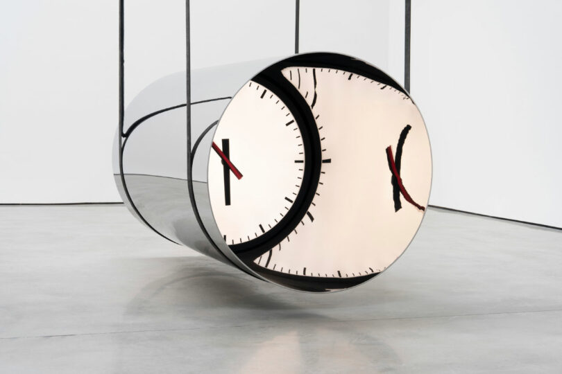 hanging mirrored cylinder with clock face inside