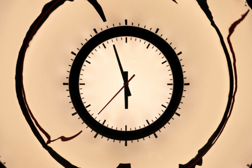 clock face in mirrored pipe