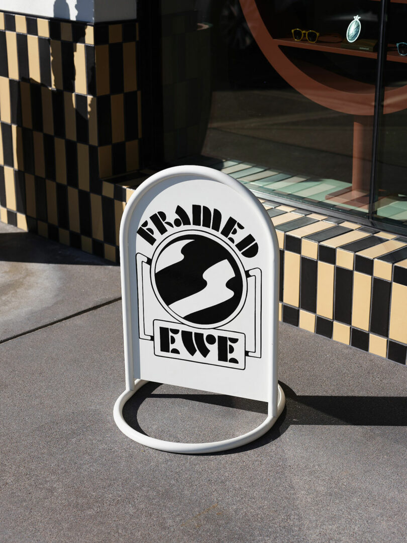 A white sidewalk sign with 