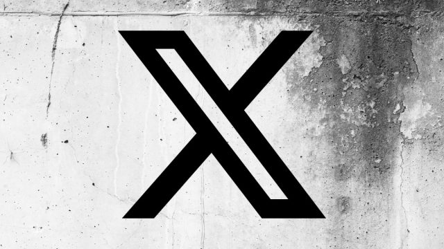 1750453802_X-app-code-points-to-a-physical-card-coming-to.jpg X (formerly Twitter) logo on a cracked wall