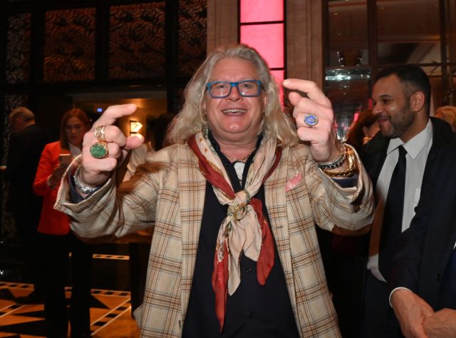 Collector-Hoping-Elon-Musk-Buys-Napoleon-Collection.jpg A man with long white hair smiling at the camera.