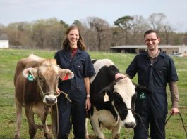 Hoofprint founders stand with two cows.