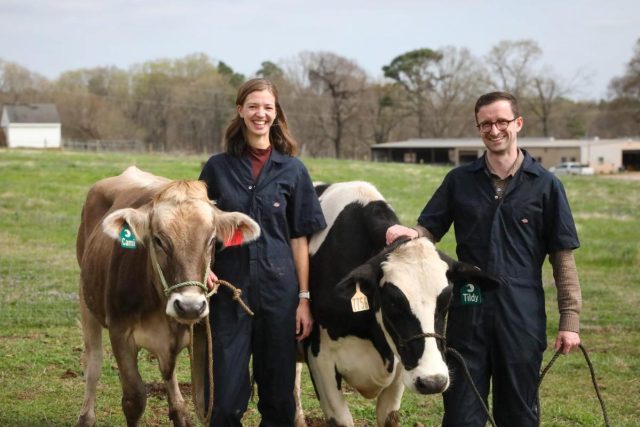 How-one-biotech-startup-is-betting-on-cows-and-winning.jpeg Hoofprint founders stand with two cows.