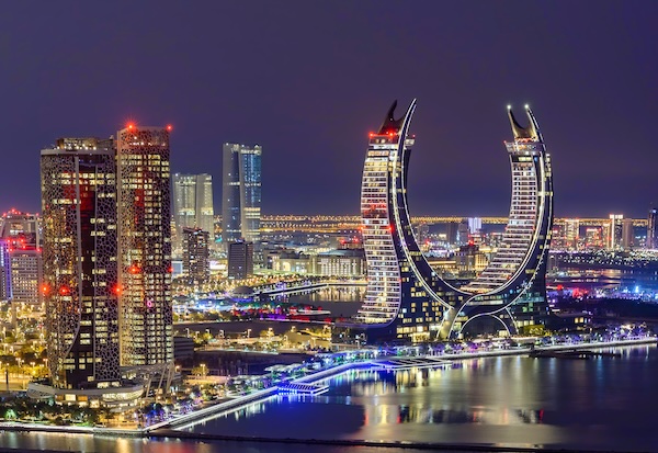 The general view of the ultra-luxury hotels Raffles and Fairmont in Doha, Qatar, on December 21, 2024. The dual-branded property is located within the iconic Katara Towers, a unique crescent-shaped building gracing the skyline of Lusail (Photo by Noushad Thekkayil/NurPhoto via Getty Images).