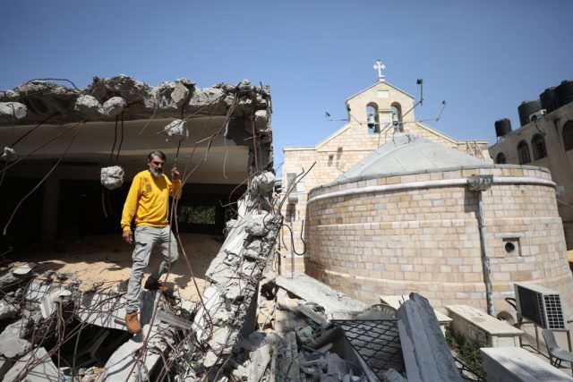 Israeli-Attacks-on-Palestinian-Heritage-Constitute-War-Crimes-Report.jpg GAZA CITY, GAZA - JUNE 3: Palestinian Christian Ramez Al-Souri, who lost his 3 children Suhail, Julie and Majd and many relatives in the Israeli attack shows the destroyed historic Greek Orthodox Church of St. Porphyrius at the Ez-Zeytun neighbourhood in Gaza City, Gaza on June 3, 2024. (Photo by Hamza Z. H. Qraiqea/Anadolu via Getty Images)