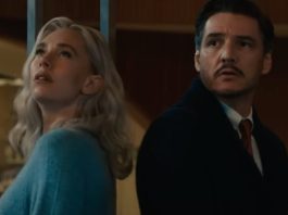 blond woman in a blue top and dark haired man in jacket and dress shirt staring up at the night sky