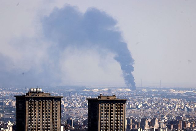 Museums-in-Tehran-and-Tel-Aviv-Move-to-Safeguard-Collections.jpg TOPSHOT - Smoke billows in the distance from an oil refinery following an Israeli strike on the Iranian capital Tehran on June 17, 2025. Israel and Iran exchanged fire again, the fifth day of strikes in their most intense confrontation in history, fuelling fears of a drawn-out conflict that could engulf the Middle East. (Photo by ATTA KENARE / AFP) (Photo by ATTA KENARE/AFP via Getty Images)