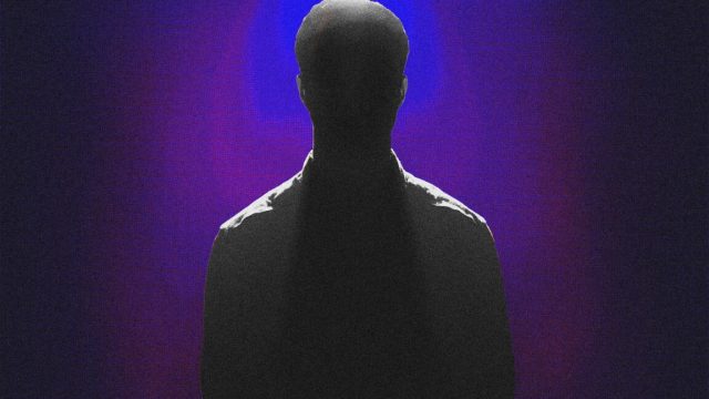 Ransomware-kingpin-Stern-apparently-IDed-by-German-law-enforcement.jpg Silhouette of a man against a dimly lit backtround