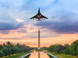 plane in flight over Washington Monument