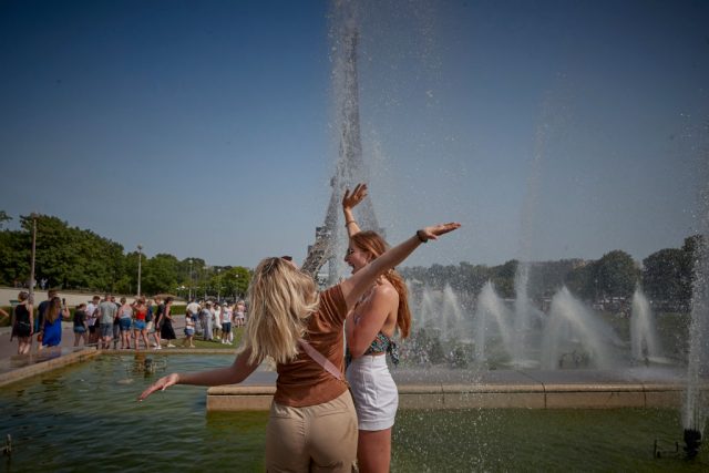 PARIS, FRANCE - JUNE 18: Tourists cool off in fountains in front of the Eiffel Tower as temperatures in the city soar toward 104°F in what is expected to be a new record for the hottest June day in the city on June 18, 2022. Outdoor public events across France have been canceled as countries across Europe face high temperatures caused by the mass of hot air moving from north Africa, causing health risks as well as wild fires and energy shortages. (Photo Kiran Ridley/Getty Images)
