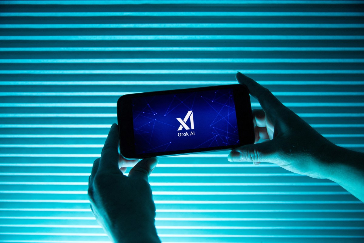 France-is-investigating-X-over-foreign-interference-while-an-MP.jpg A person holds a telephone displaying the logo of Elon Musk s artificial intelligence grok in front of a background lit by a blue light.