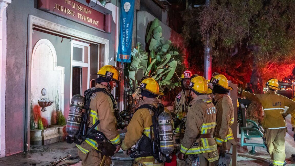 LAs-Museum-of-Jurassic-Technology-damaged-by-fire.jpg firefights standing outside museum building at night in Los angeles.