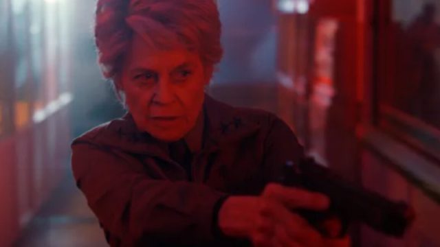 Linda-Hamilton-rocks-Stranger-Things-S5-extended-teaser.jpg older woman with short gray hair looking grim while pointing a revolver