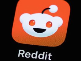 A Reddit app icon on a phone screen.