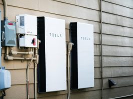 Two Tesla Powerwalls sit on the outside of a house.