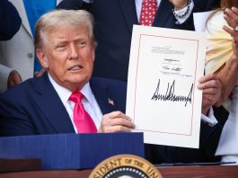 U.S. President Donald Trump, joined by Republican lawmakers, signs the One, Big Beautiful Bill Act into law during an Independence Day military family picnic on the South Lawn of the White House on July 04, 2025 in Washington, DC.