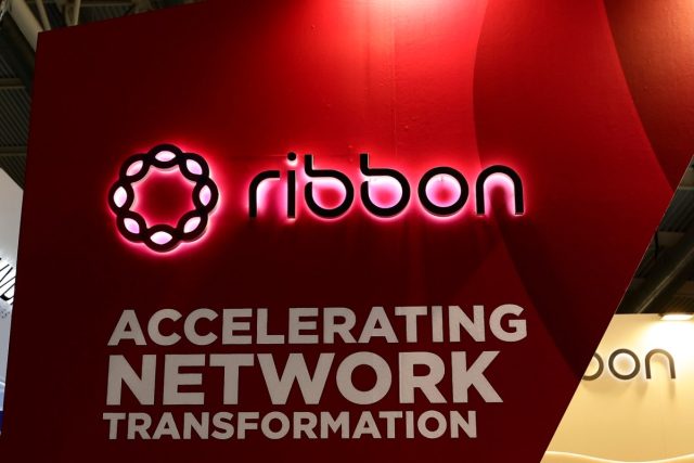 Government-hackers-breached-telecom-giant-Ribbon-for-months-before-getting.jpg a photo showing Ribbon Communicatons' signage on a red background